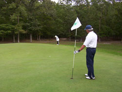 Green Tree Golf Course golfers on putting green.